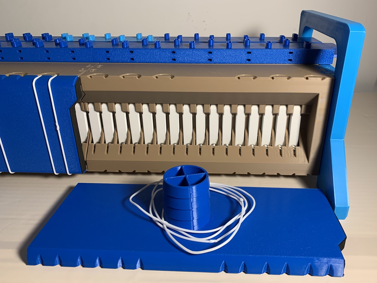 The open wind chest showing the white pallet valves and a blue back panel