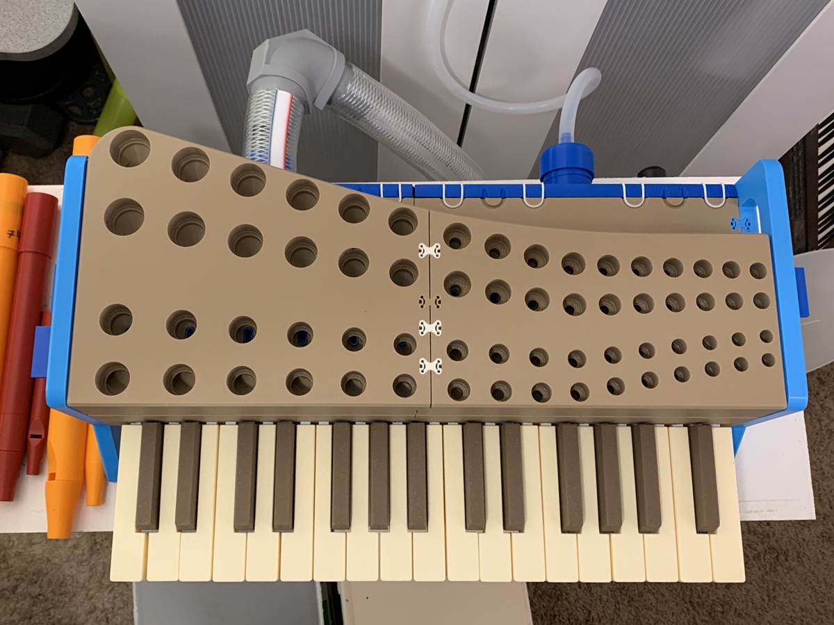 The keyboard from above with the pipes removed, showing the holes in the toeboard