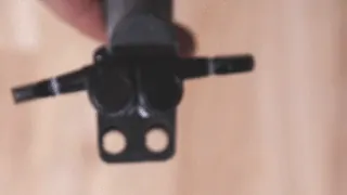 Hands fitting tuner pegs into the printed head