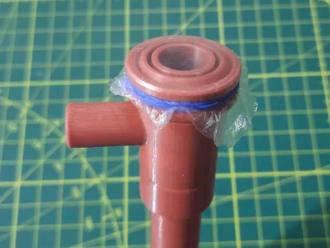 Close-up of the mouthpiece with plastic film held on by a blue rubber band